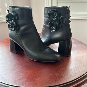 Tory Burch black leather ankle boot in size 8.5. leather flowers on each side